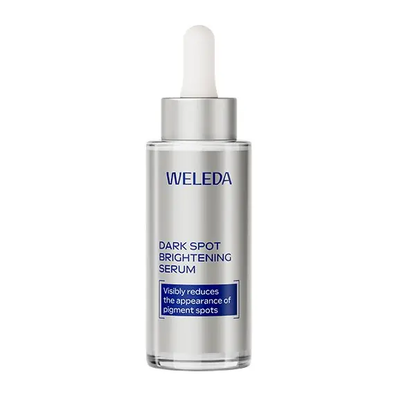 Weleda Dark Spot Brightening Serum bottle with dropper, silver packaging and blue label indicating pigmentation reduction.",