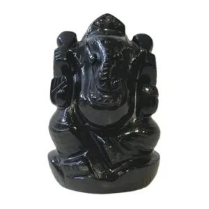 Glossy black statue of Hindu god Ganesha, seated with elephant head and arms resting.