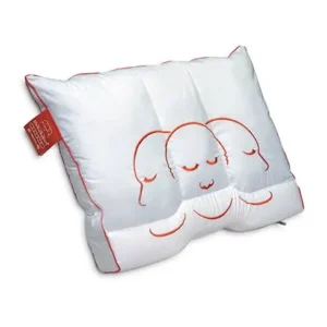 White decorative pillow featuring three orange, sleeping-face outlines and red piping with a small red tag on the side.
